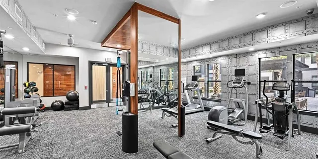 a room with stainless steel appliances kitchen island a table and chairs