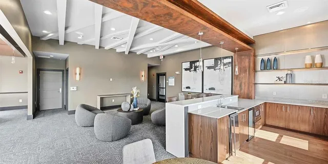 a living room with furniture and large windows