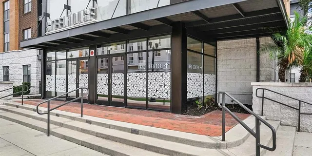 a view of a dining room with furniture and a window