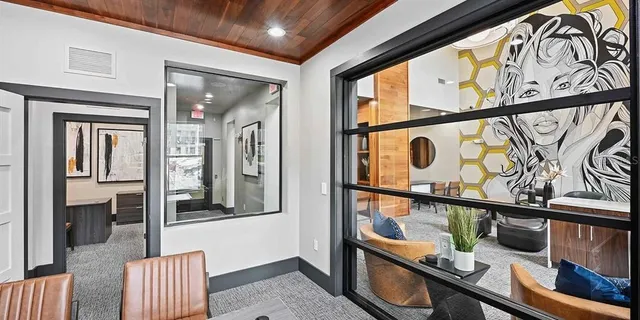 a living room with furniture dining table and a large window