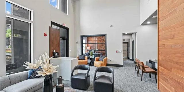 a living room with furniture and wall paintings