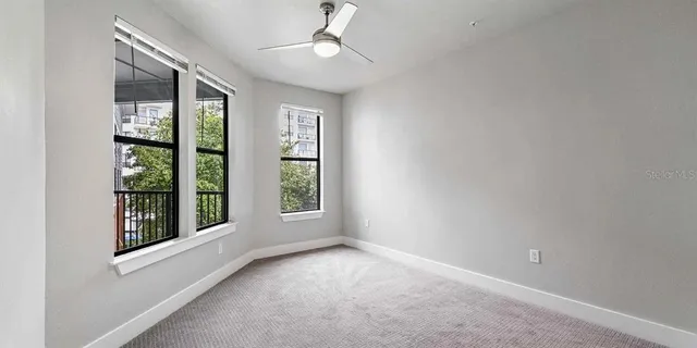 an empty room with windows and outdoor view