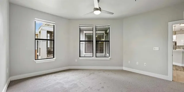 an empty room with windows and windows