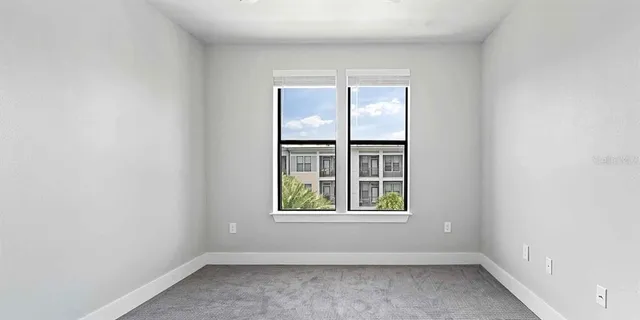 an empty room with windows and closet