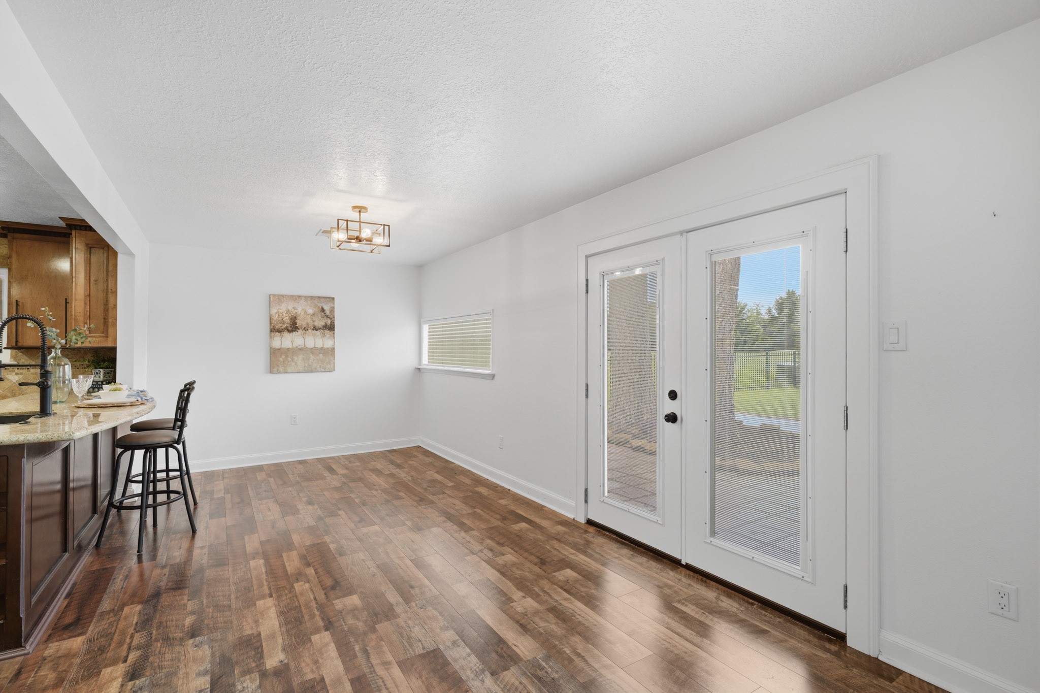 79 Summers Wind Street Conroe, TX 77356 - Photo 10 of 45 an empty room with windows and wooden floor