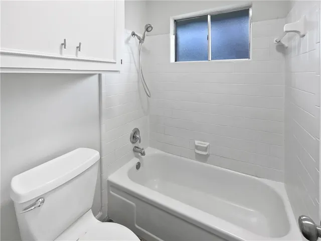 a bathroom with a toilet and a tub