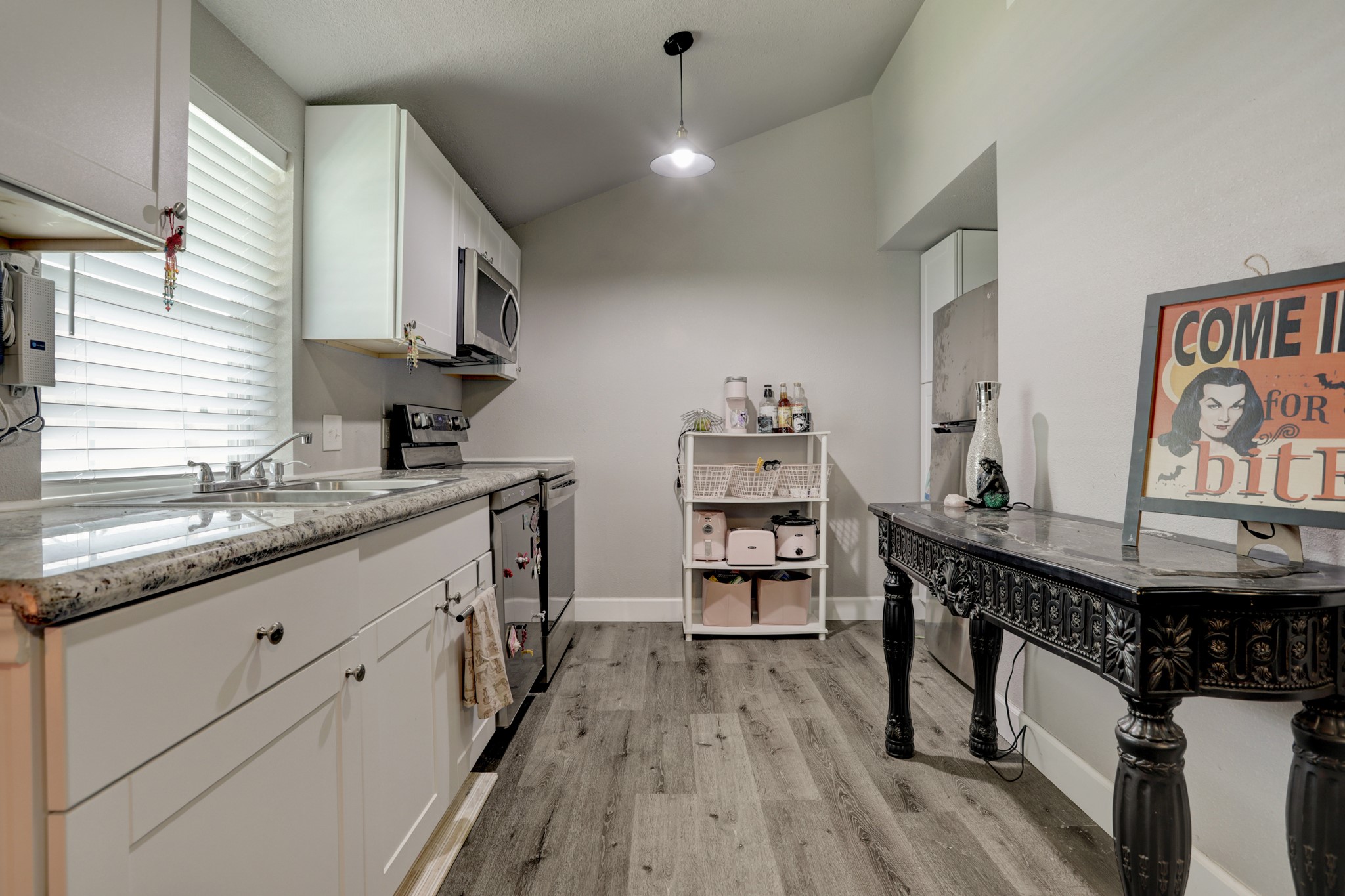 2322 Central Street Dickinson, TX 77539 - Photo 12 of 25 a kitchen with sink cabinets and wooden floor