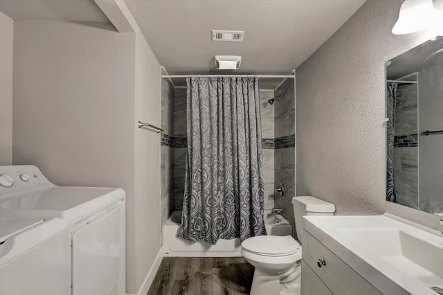 a bathroom with a sink toilet and shower
