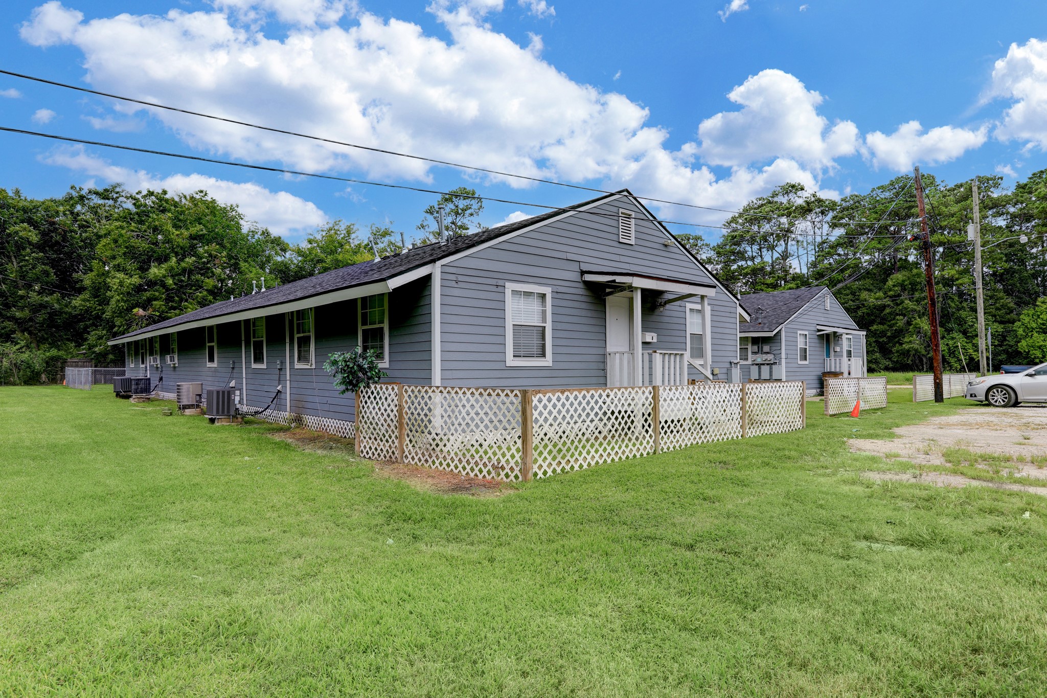 2322 Central Street Dickinson, TX 77539 - Photo 2 of 25 a front view of a house with a garden and trees