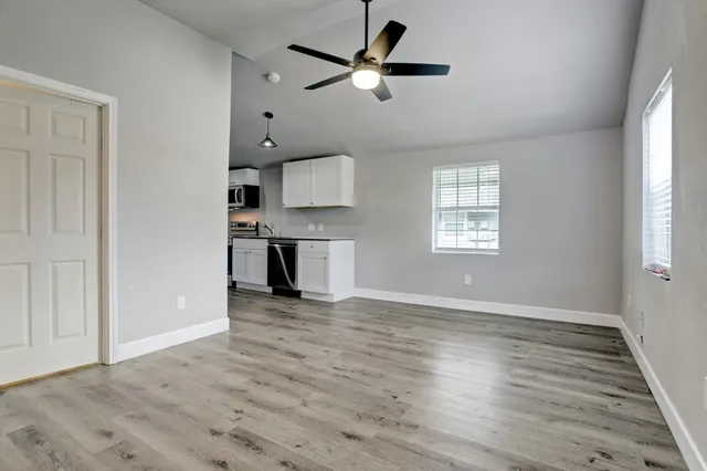 wooden floor in an empty room with a window