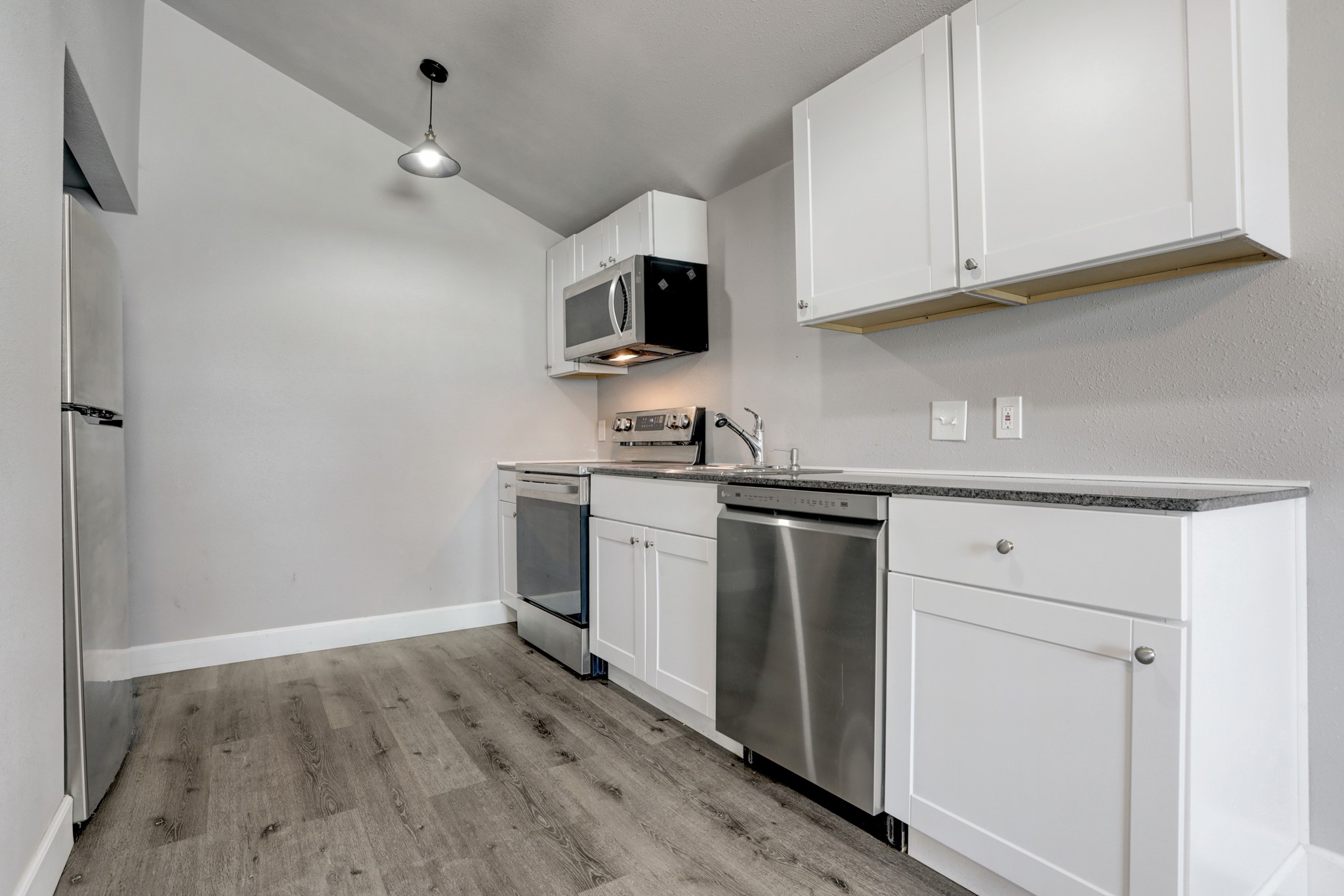2322 Central Street Dickinson, TX 77539 - Photo 8 of 25 a kitchen with white cabinets and appliances