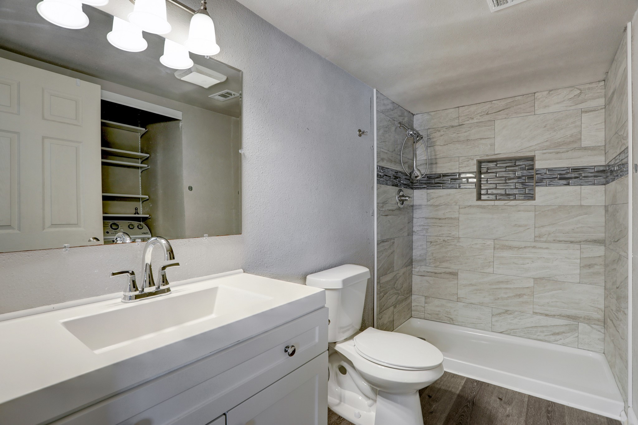 2322 Central Street Dickinson, TX 77539 - Photo 9 of 25 a bathroom with a sink a toilet and a mirror