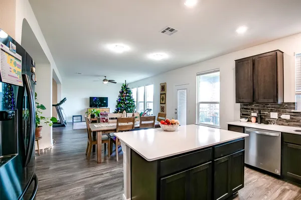 a kitchen with a sink appliances and cabinets
