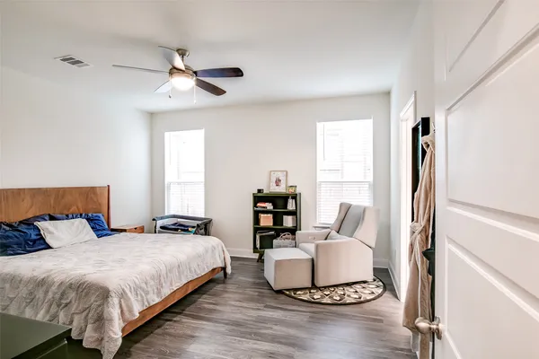 a bedroom with a bed and a large window