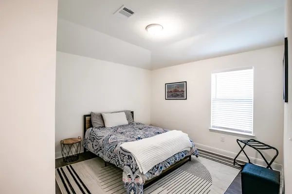 a bedroom with a bed and a window