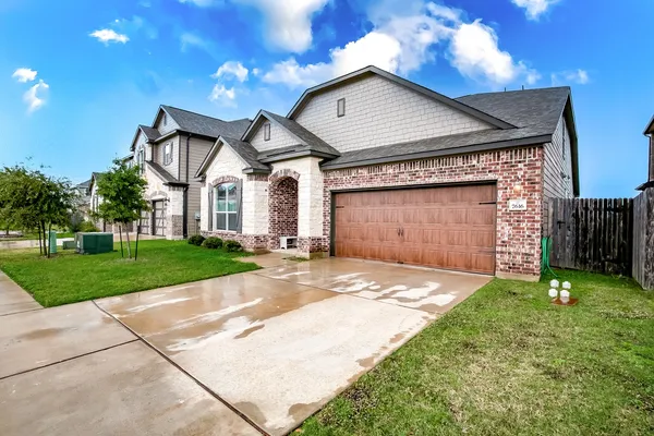 a front view of a house with a yard and garage