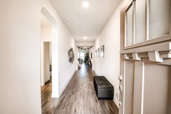 a hallway with a couch and wooden floor