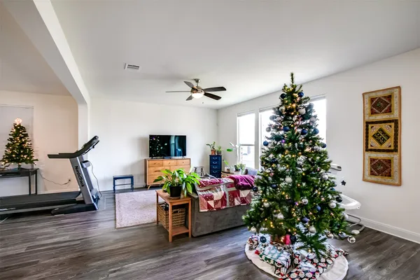 a living room with furniture and a potted plant
