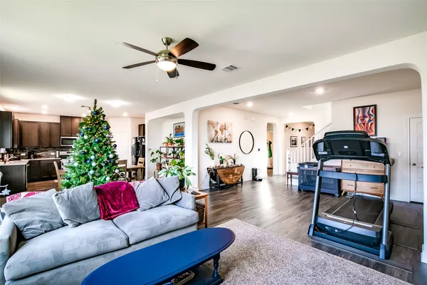 a living room with furniture and wooden floor