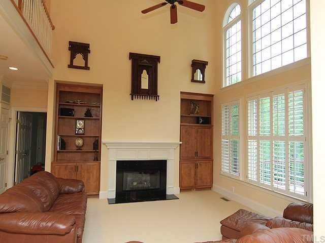 5201 Azure Lane Raleigh, NC 27613 - Photo 6 of 12 Gracious and spacious Family room with cathedral ceiling, gas log fireplace and built-in book cases. It offers so much light with a wall of windows, and opens to the kitchen. It invites family and friends to sit awhile for a visit...