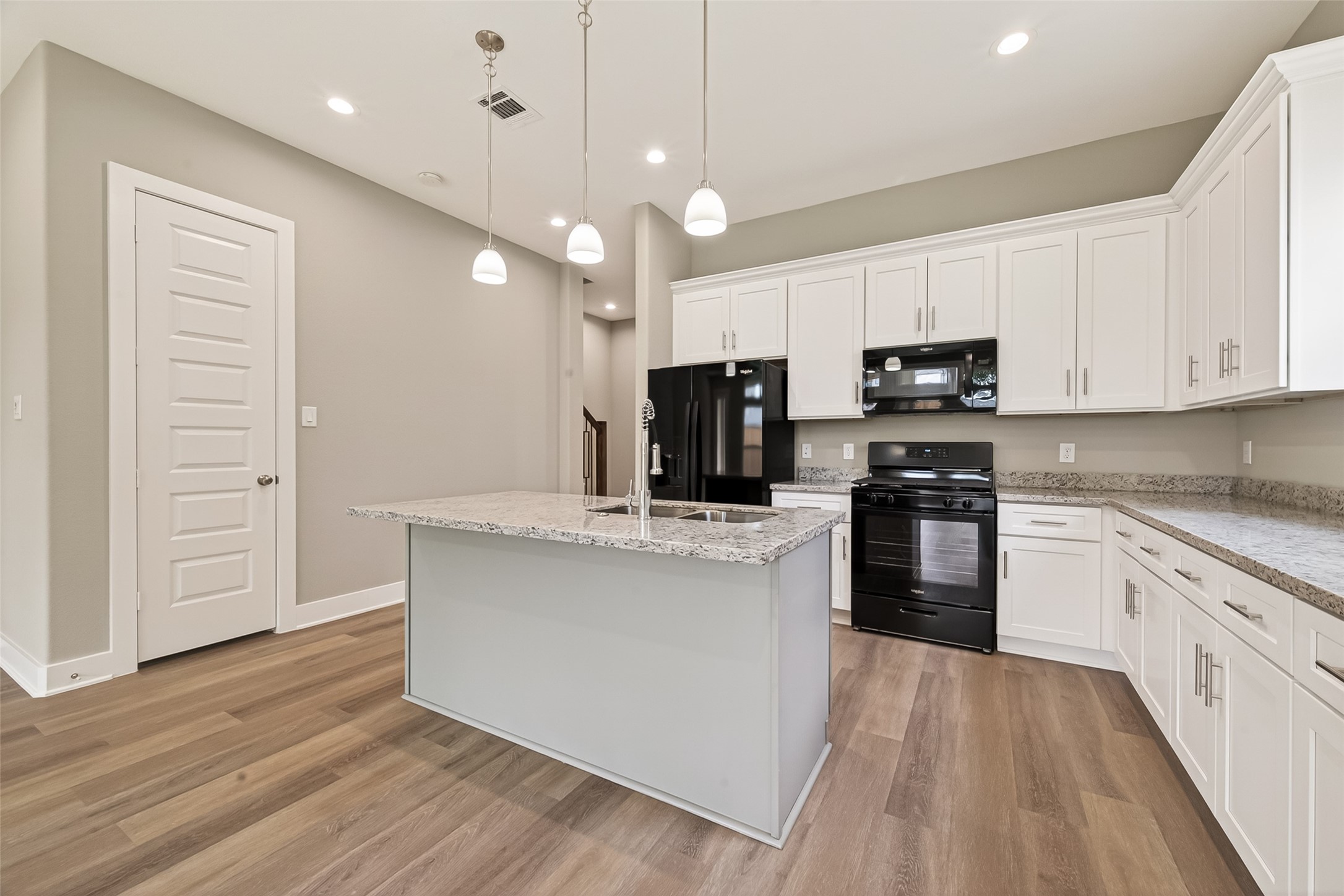3514 Runnels Street, Unit B Houston, TX 77003 - Photo 8 of 39 Three pendants offer task lighting over the island, which includes the oversized sink and new dishwasher.