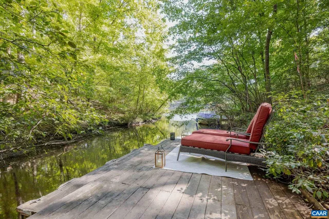 a view of a yard with a bench and lake view