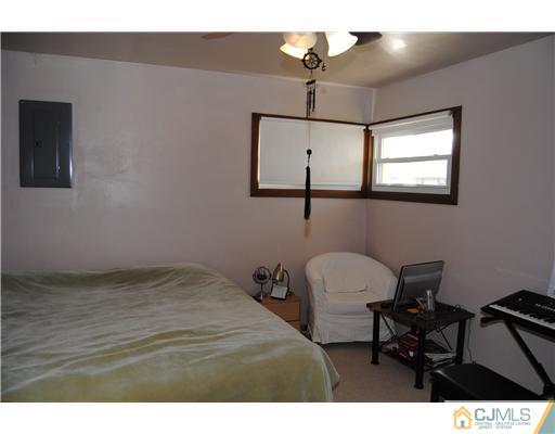 130 Idlewild Road Edison, NJ 08817 - Photo 8 of 12 a view of a workspace with furniture and a ceiling fan