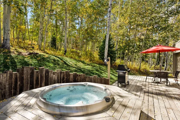 a backyard of a house with table and chairs