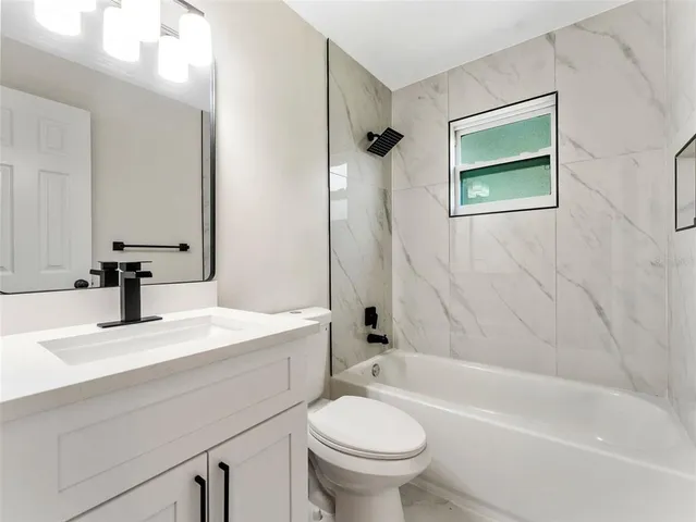 a bathroom with a sink a toilet and a bathtub