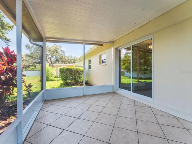 a view of an empty room with windows