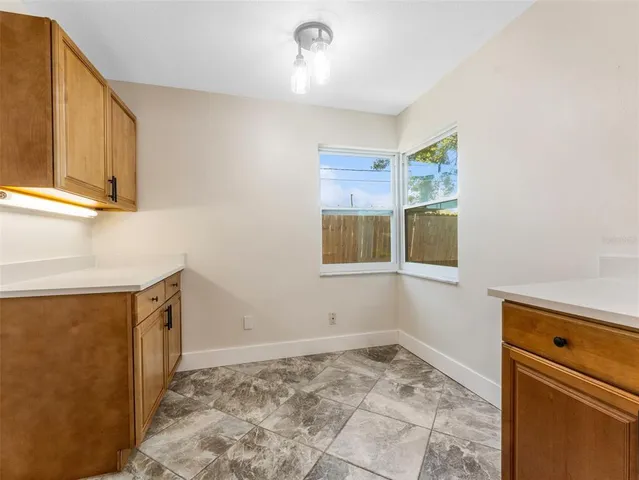 a view of a kitchen with a sink and cabinets