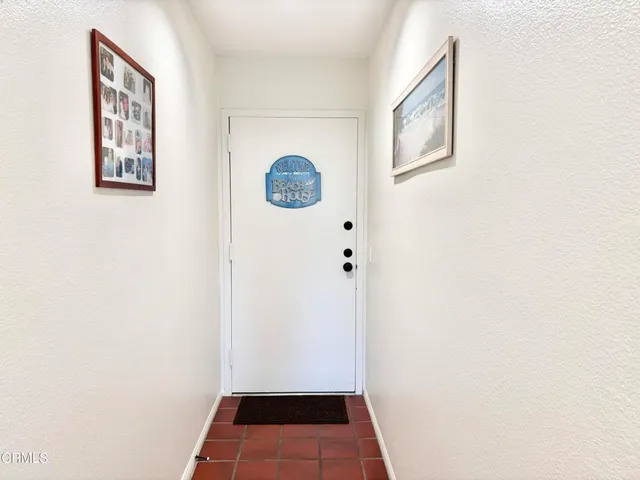 a view of an entryway with wooden floor