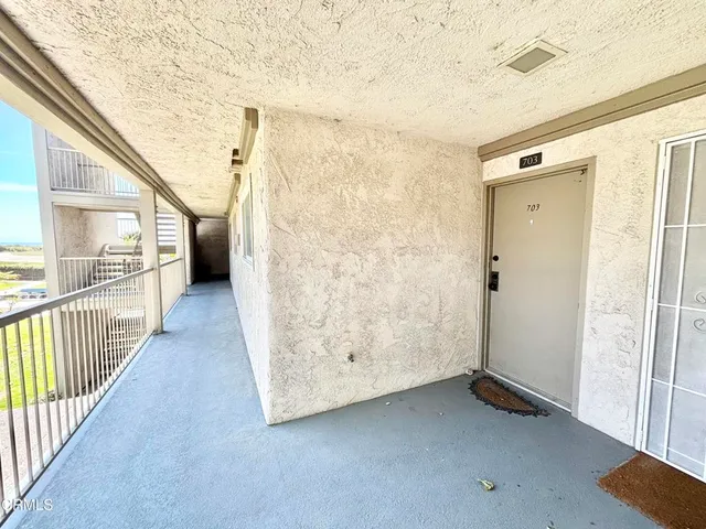 a view of a porch with wooden floor and door
