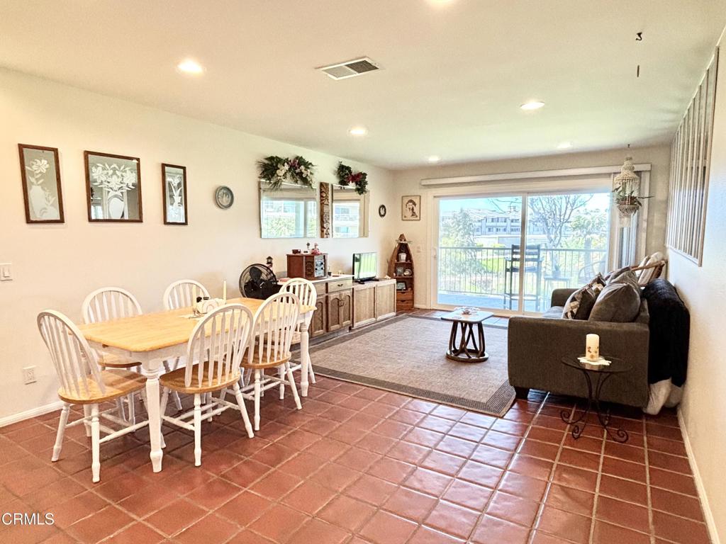 703 Reef Circle Port Hueneme, CA 93041 - Photo 2 of 24 a living room with furniture and a floor to ceiling window