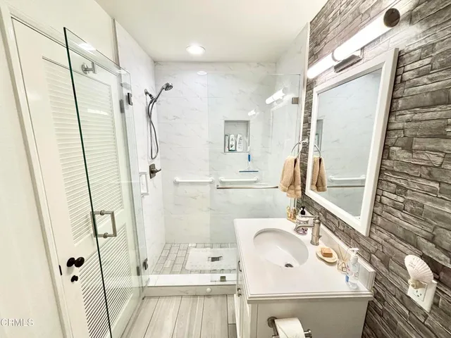 a bathroom with a sink a mirror and a shower