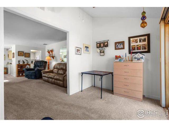 a living room with furniture and a dresser
