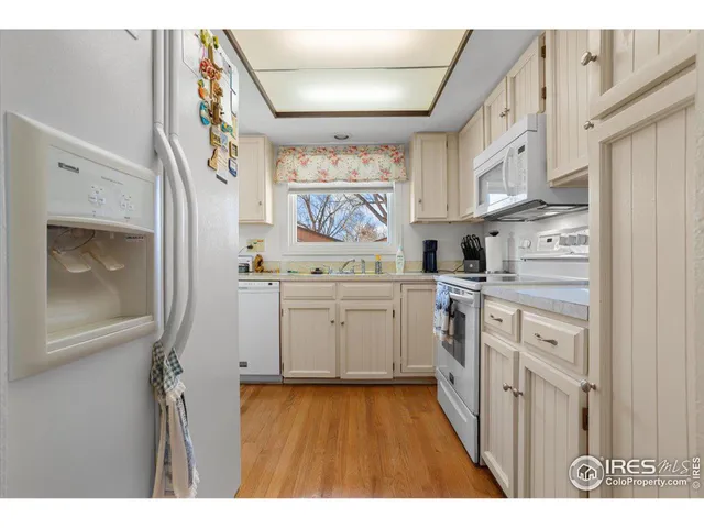 a kitchen with stainless steel appliances a white stove top oven and a refrigerator