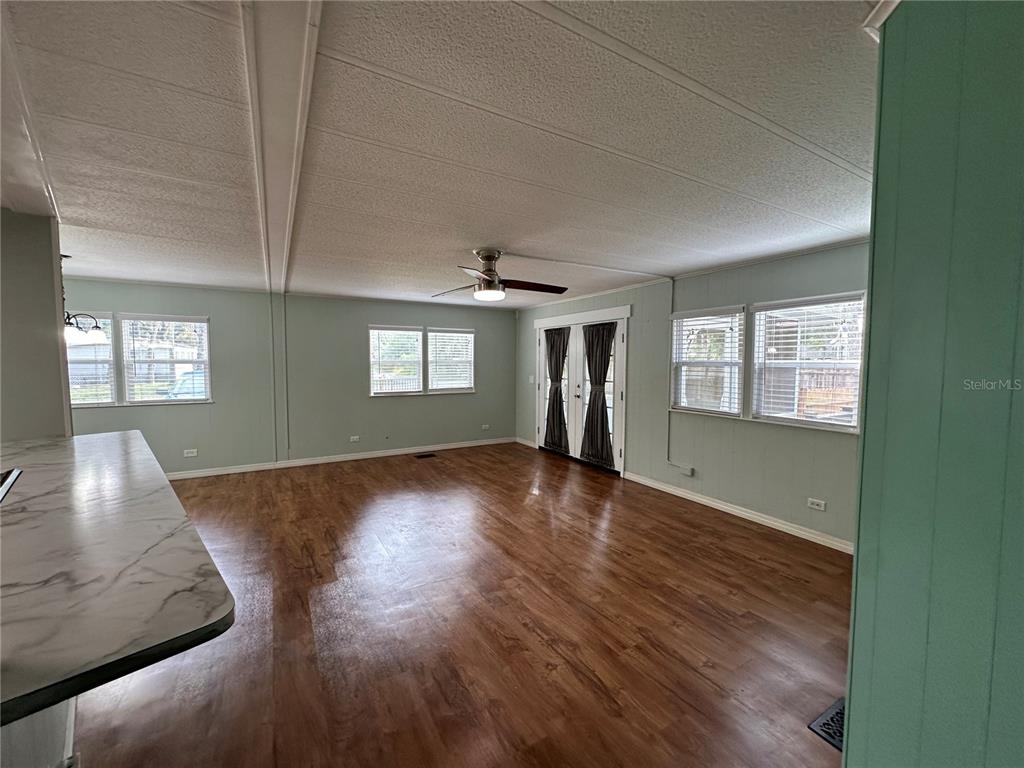 24007 River Road Astor, FL 32102 - Photo 12 of 37 a view of an empty room with wooden floor and a window