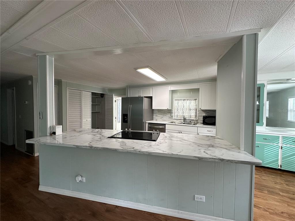 24007 River Road Astor, FL 32102 - Photo 13 of 37 a view of living room with granite countertop furniture and flat screen tv