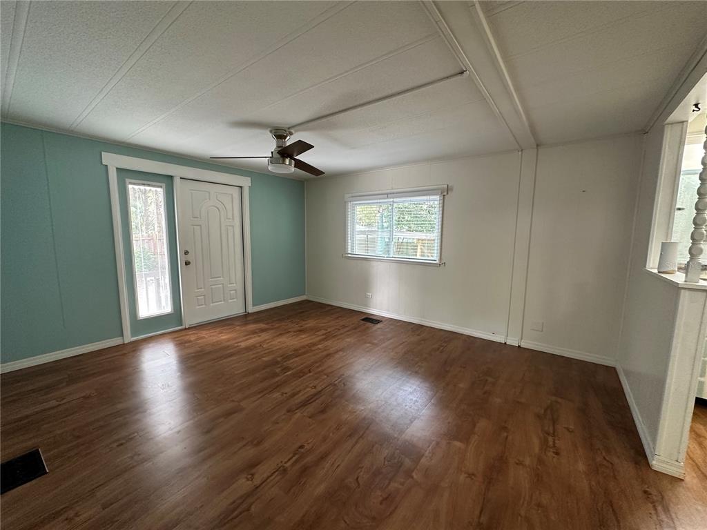 24007 River Road Astor, FL 32102 - Photo 19 of 37 an empty room with wooden floor and windows