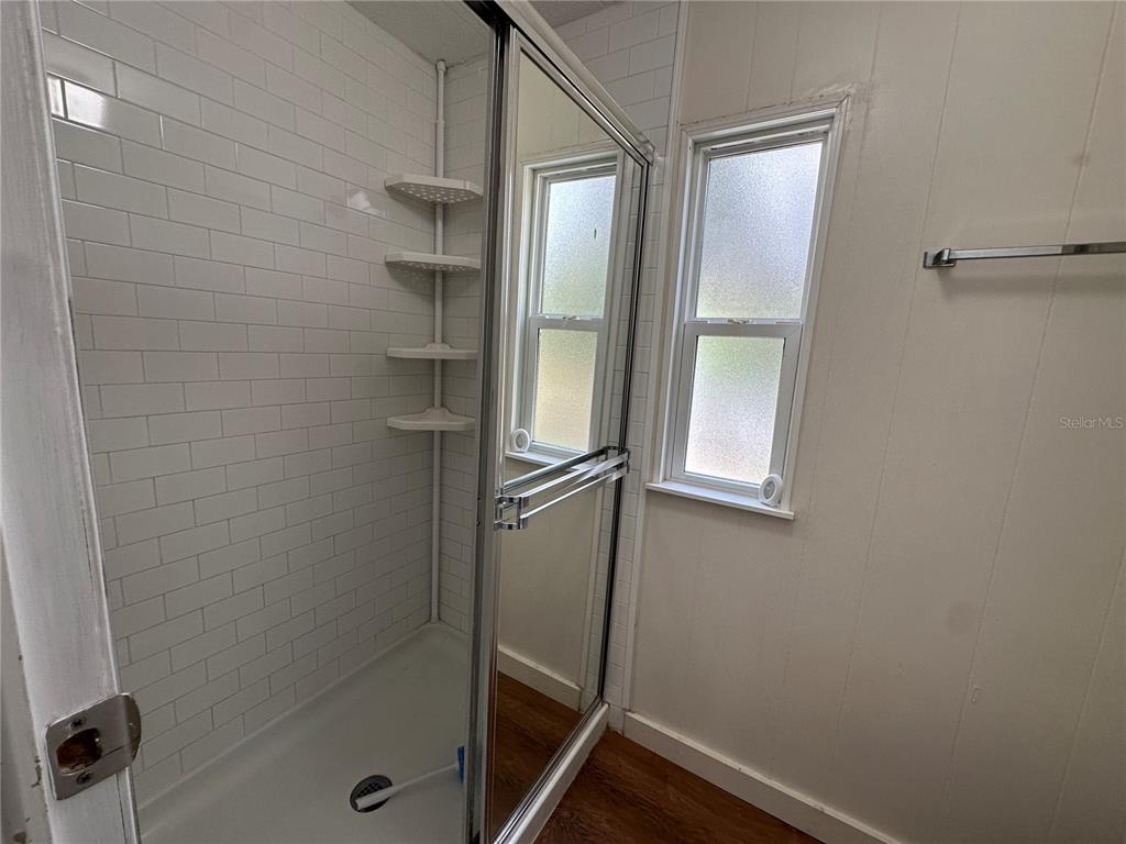 24007 River Road Astor, FL 32102 - Photo 23 of 37 a bathroom with a glass door shower