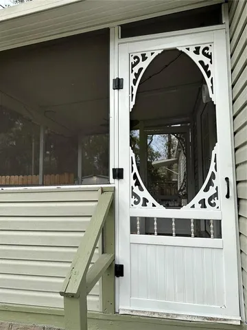 a view of a backyard with wooden fence