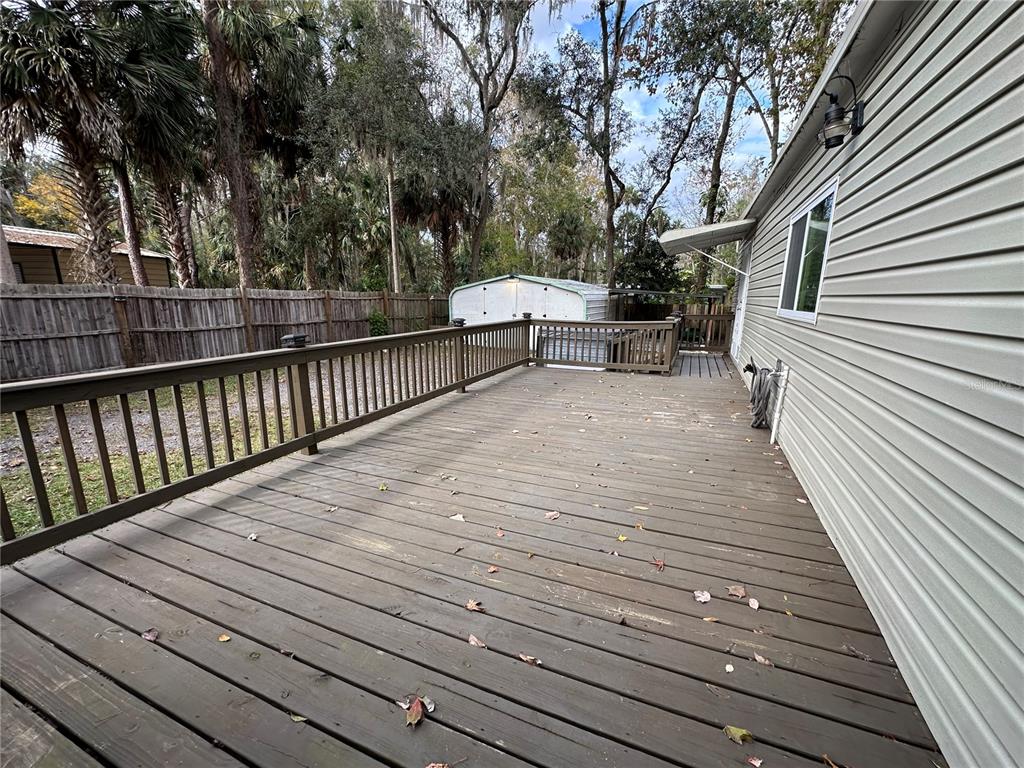 24007 River Road Astor, FL 32102 - Photo 29 of 37 a view of backyard with a deck and wooden floor