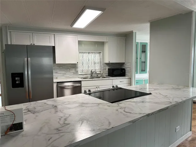 an empty room with wooden floor and a window