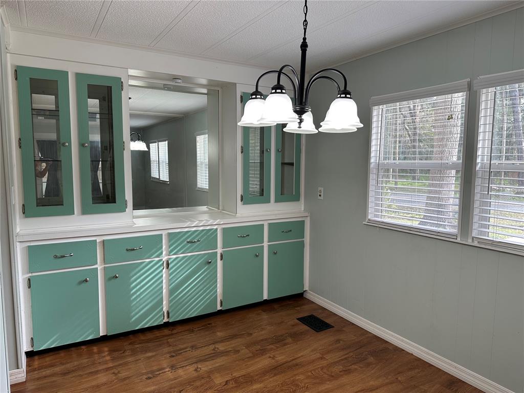 24007 River Road Astor, FL 32102 - Photo 7 of 37 a view of a room with a large window and wooden floor