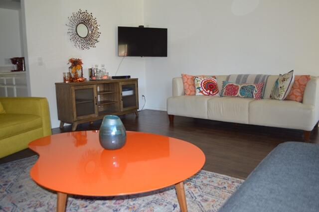 a living room with furniture and a flat screen tv