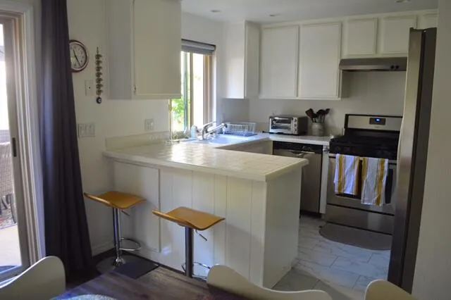 a kitchen with sink cabinets and appliances