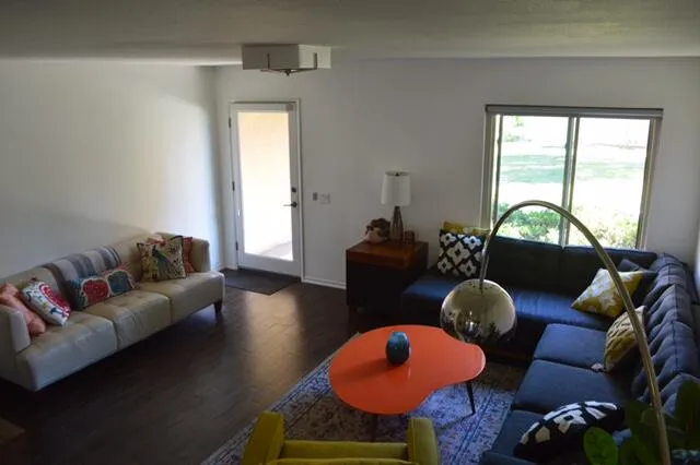 a living room with furniture and wooden floor