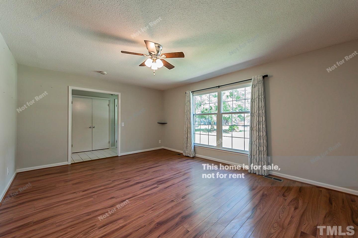 1338 Sedwick Road Durham, NC 27713 - Photo 13 of 20 a view of an empty room with wooden floor and a window