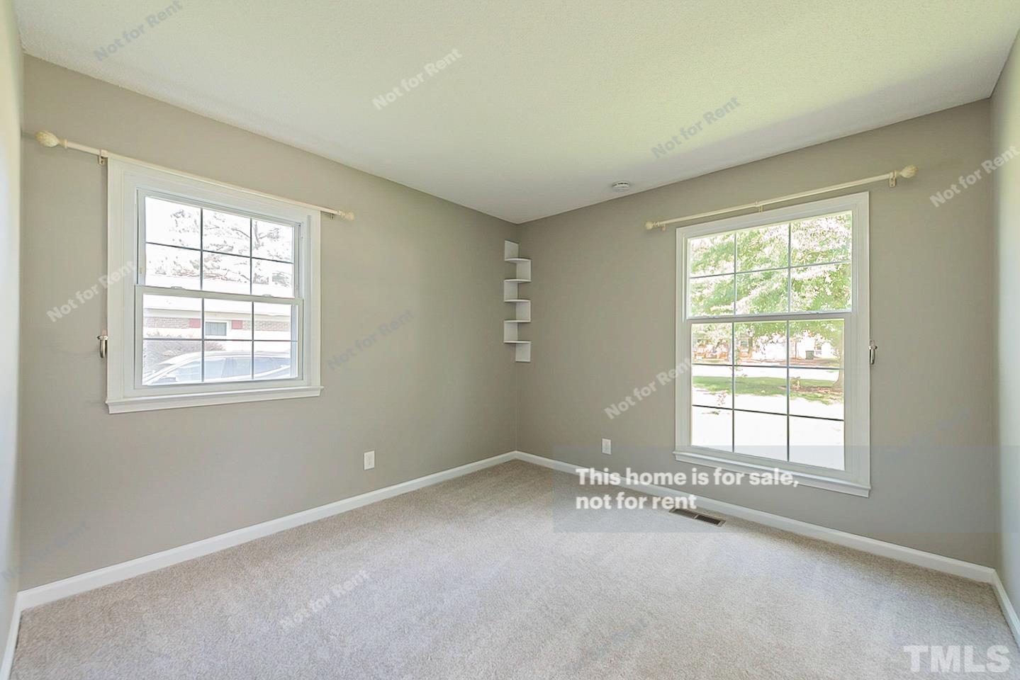 1338 Sedwick Road Durham, NC 27713 - Photo 15 of 20 a view of a big room with windows and chandelier fan